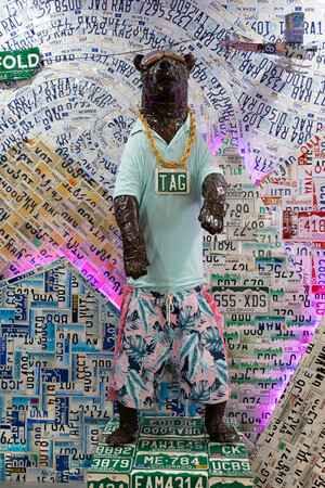 a statue of a person wearing a necklace and shorts